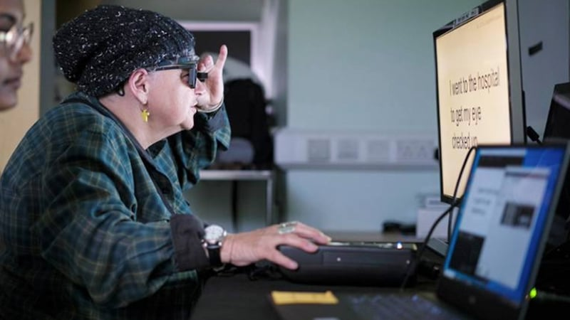 A patient wearing augmented-reality glasses uses the PRIMA vision system to read text